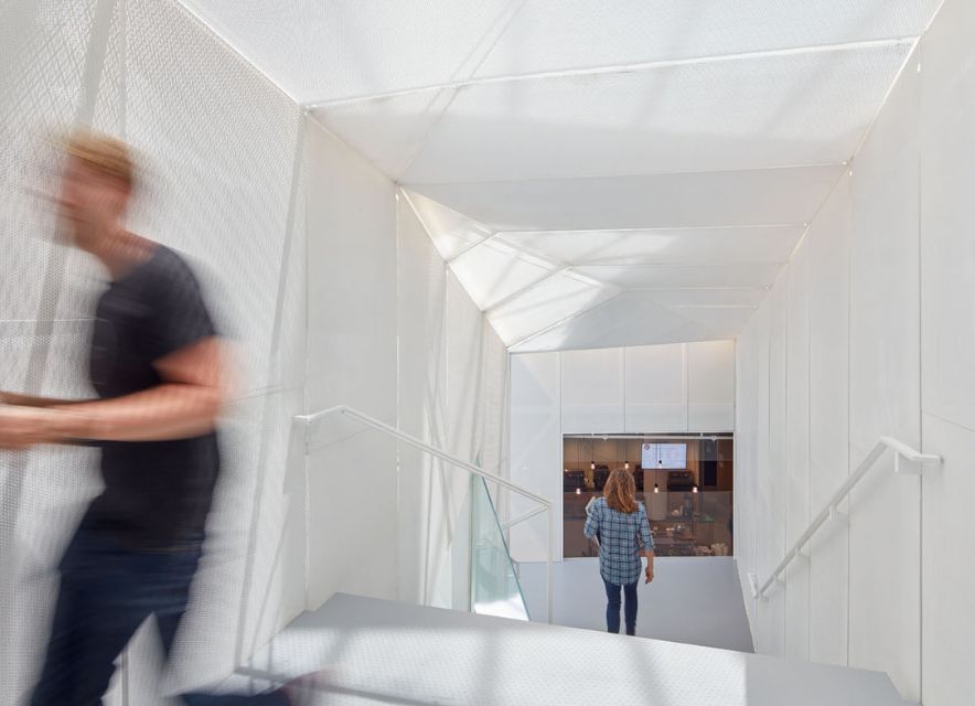 man and woman in white stairwell at Pinterest headquarters