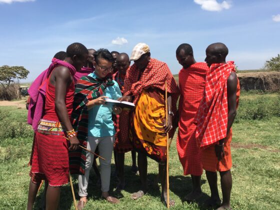 Western Dressed Man Surrounded by a group of African Friends