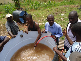 men filling up water tank
