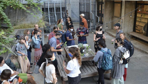 a group of people standing around a table