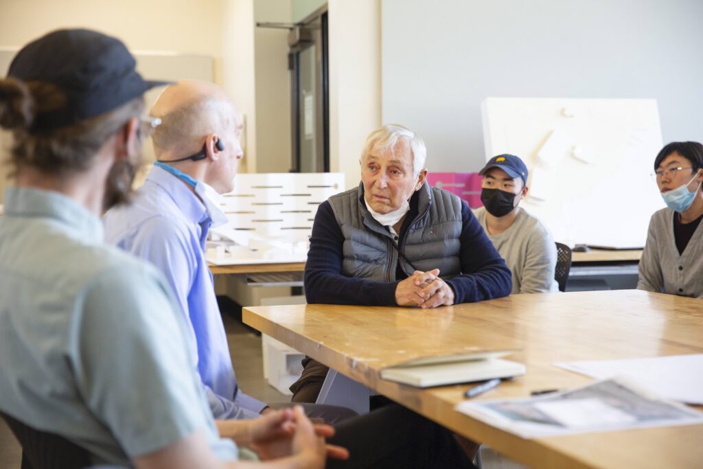 Professor raymond lifchez sitting at a table with professor chris downey