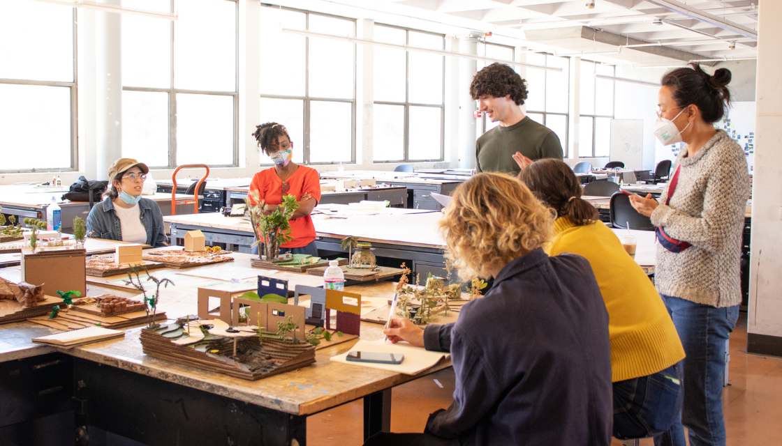 6 students presenting their models to instructor in studio