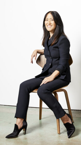Lisa Iwamoto sitting on a chair for a portrait