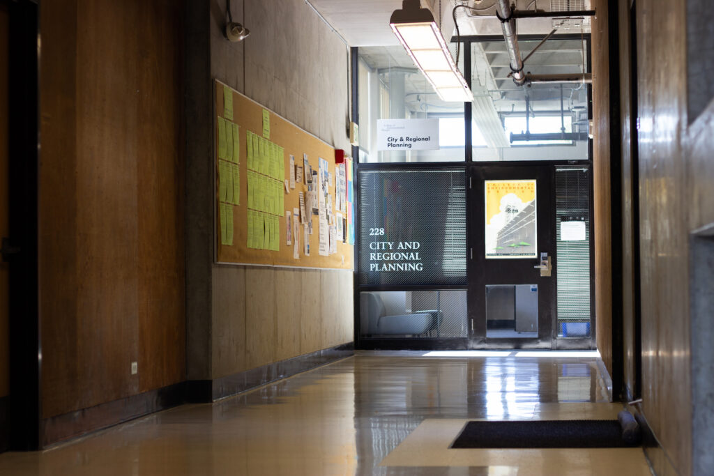 a hallway with a bulletin board on the wall