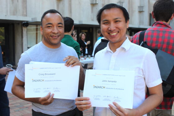 Two [IN]ARCH students holding their certificates