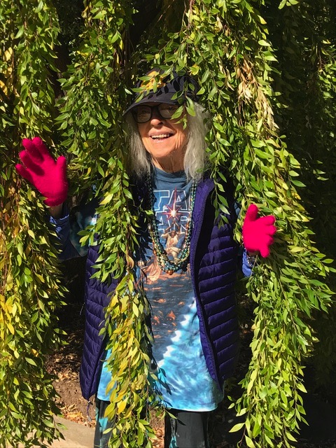 An older Penny Dhaemers peeking out from some vines