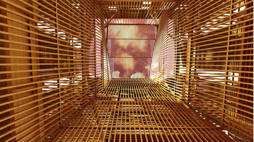 View up inside a shaft made from narrow wooden slats.