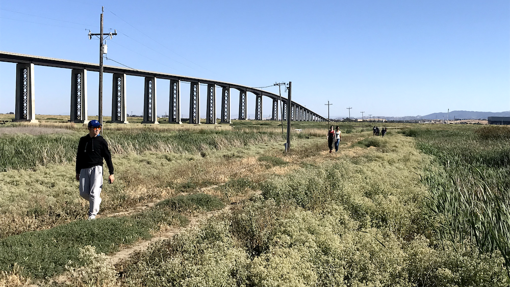 people walking along river