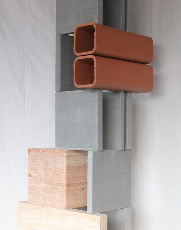 The column of an ultramoderne building constructed of concrete slabs, hollow brick, and wooden blocks