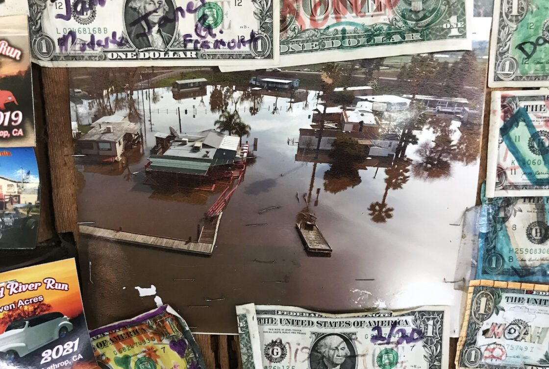 Multimedia work displaying a photo of flooding in stockton within a framing of dollar bills