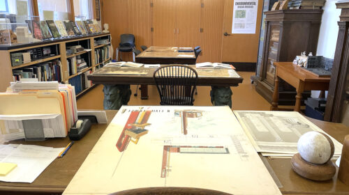View of room with architectural drawings displayed on tables