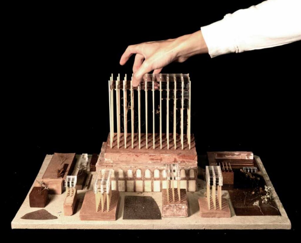 Hand placing piece on architectural model