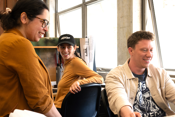 students with professor in studio laughing