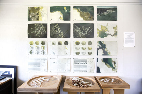 a group of wooden tables with maps on the wall