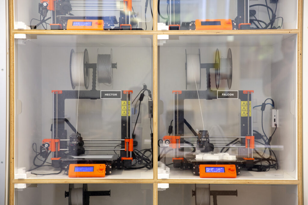 a group of three dimensional objects on a shelf in digital lab