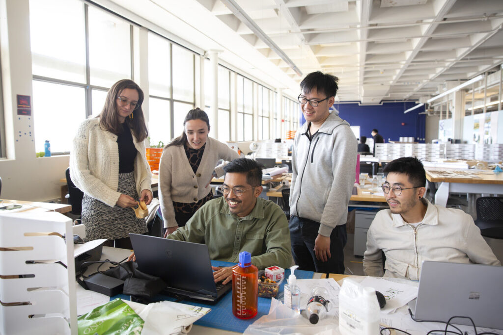 group of students smiling in architecture studio