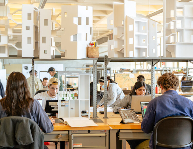 Students in architectural studios with laptops, books, and architectural models