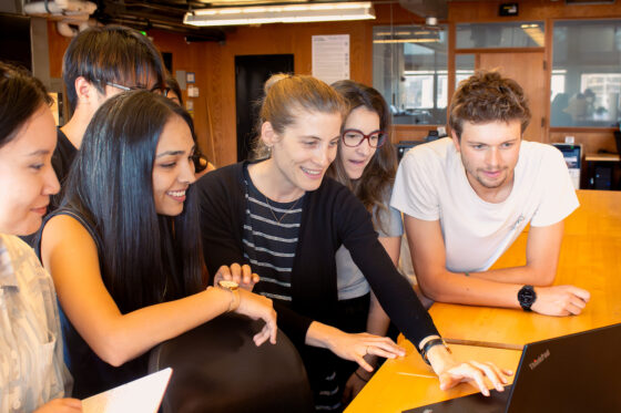 Students looking together at a laptop