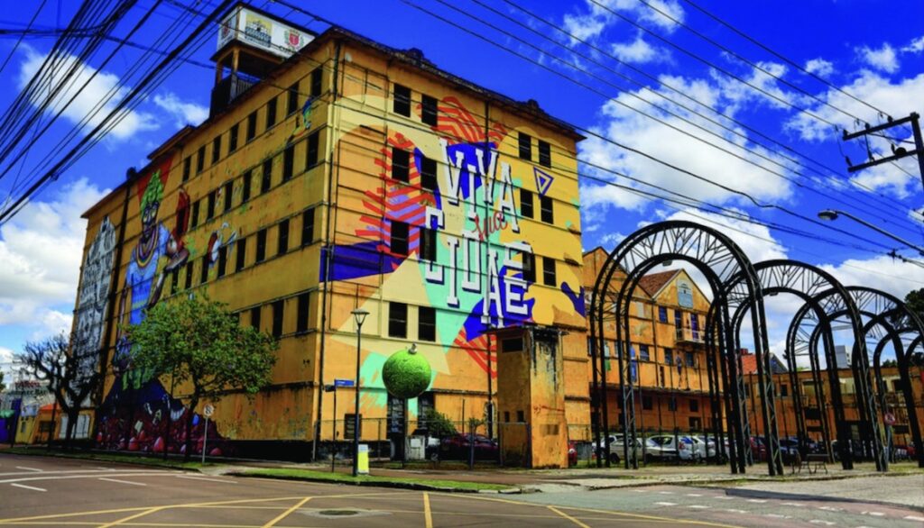 Building on corner with brightly colored murals