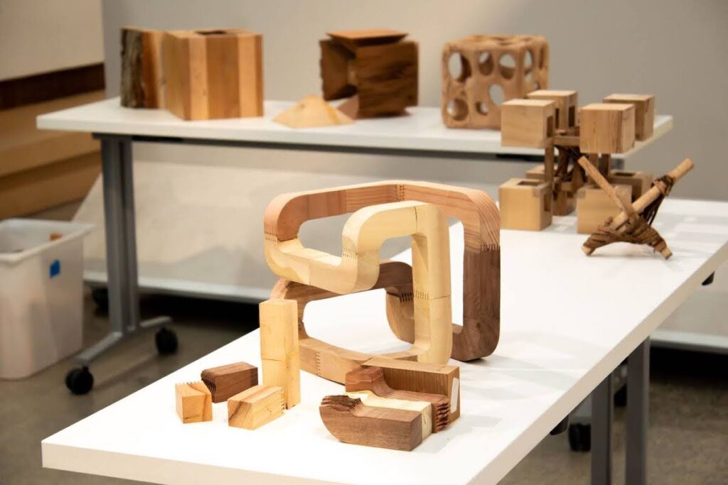 Wood constructions displayed on table