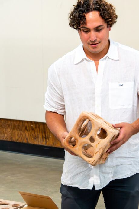 Master of Advanced Architectural Design student holding wood architectural model