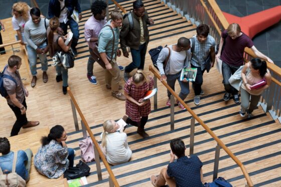 National Center for School Infrastructure elevated view of university students walking up and down stairs