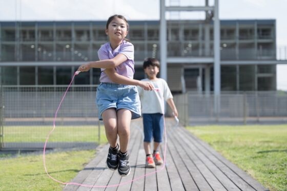 Center for Cities and Schools elementary school children, girls and boys, jumping rope in school yards.