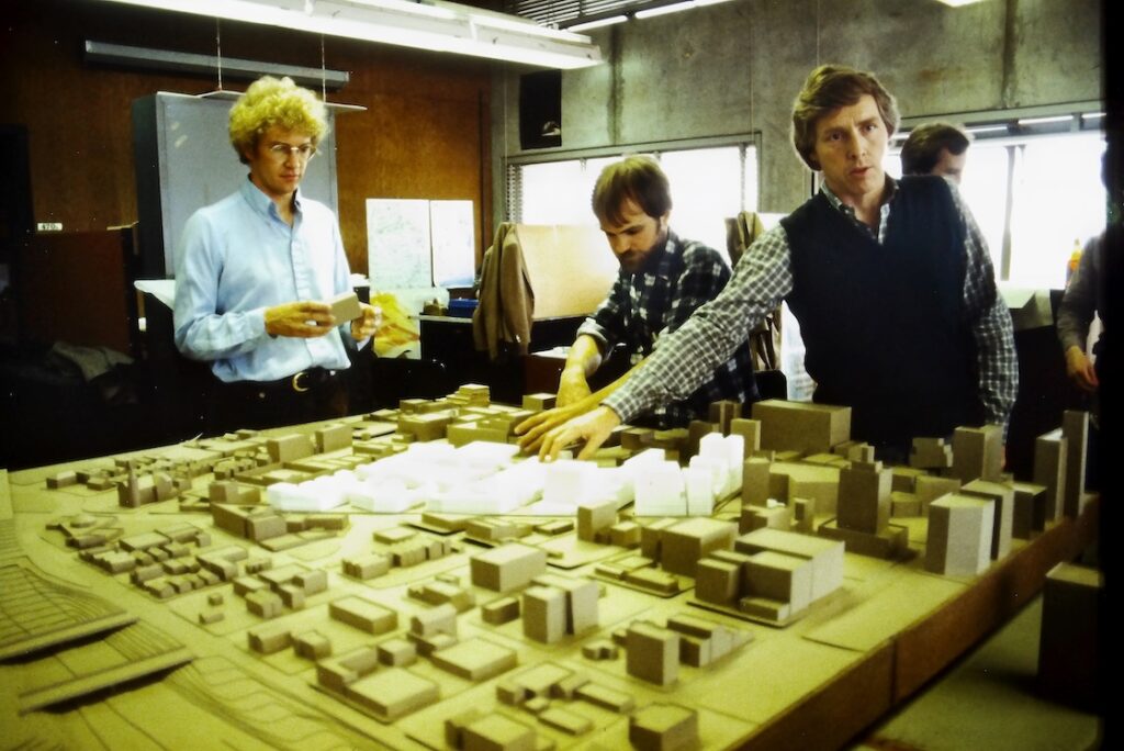 Professor in Bauer Wurster Hall pointing at a site model