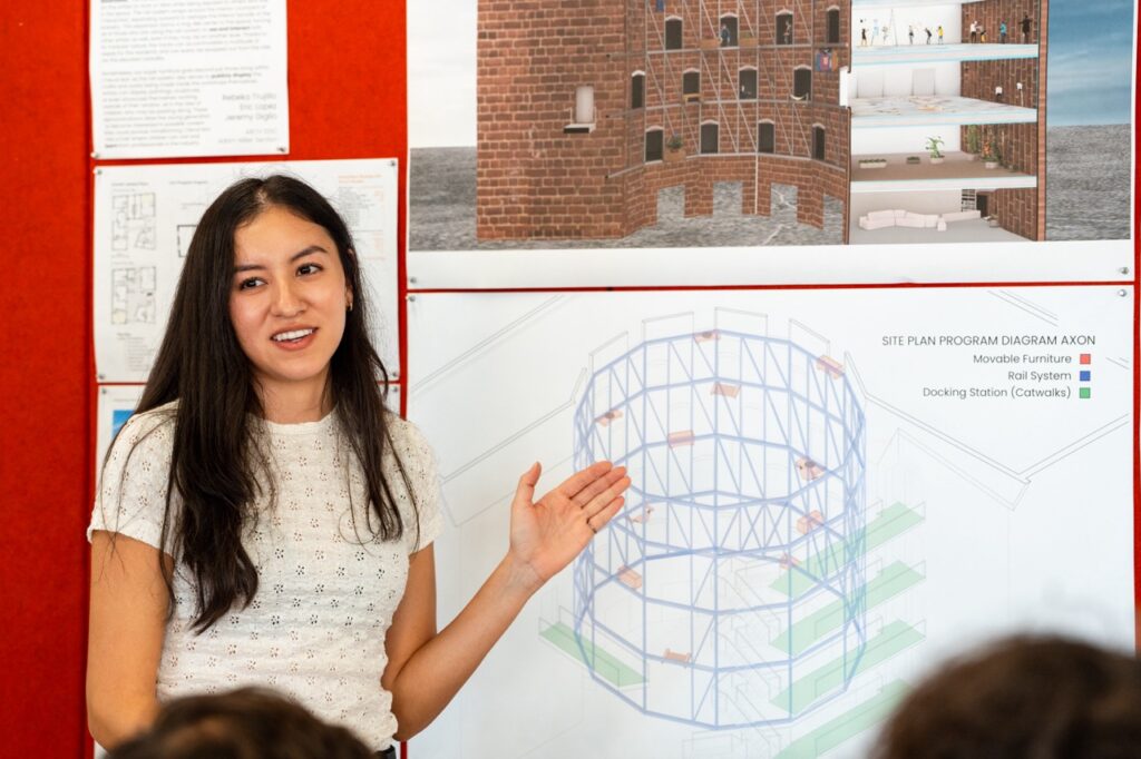 Graduate master of architecture student presenting work at final review.