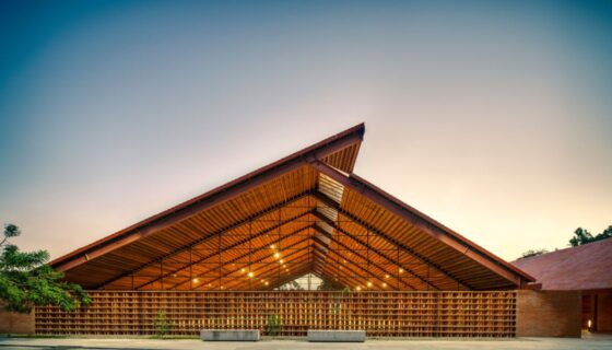 Wood building with sunset behind designed by Gabriela Carrillo