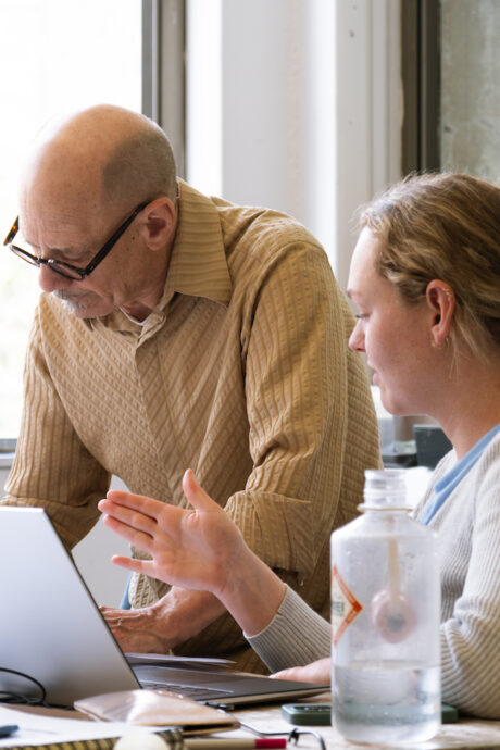 professor and student in front of laptop computer