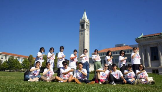 Group of students with campus bell tower in background