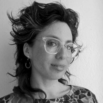 black & white headshot of a woman with glasses