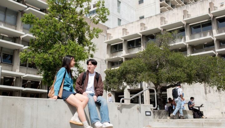 Students in plaza in front of building