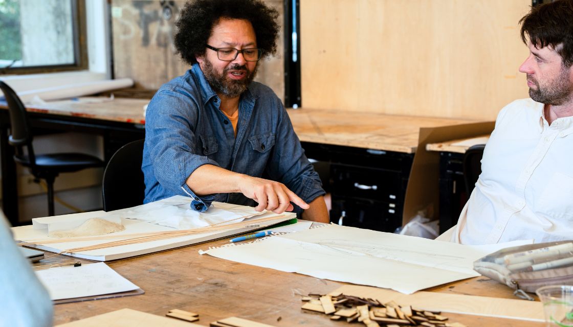David Brown and student looking at sketches