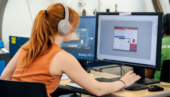 Student wearing headphones working at a computer
