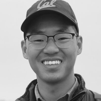 headshot of a man with CAL baseball cap and glasses