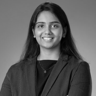 Lakshana S smiling in a suit
