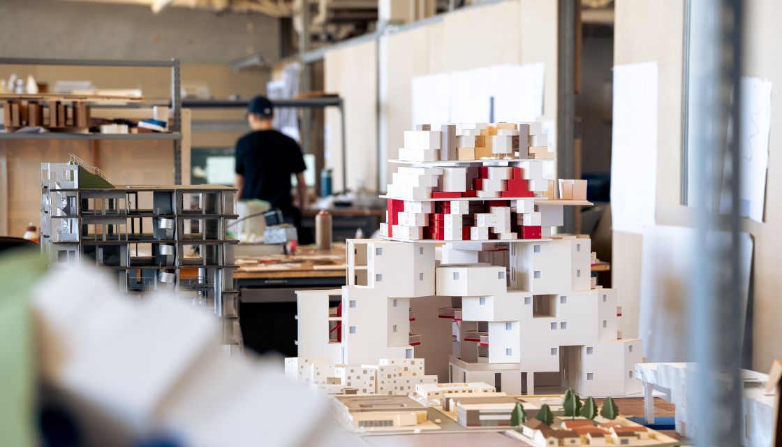 Graduate architecture studio with models and papers