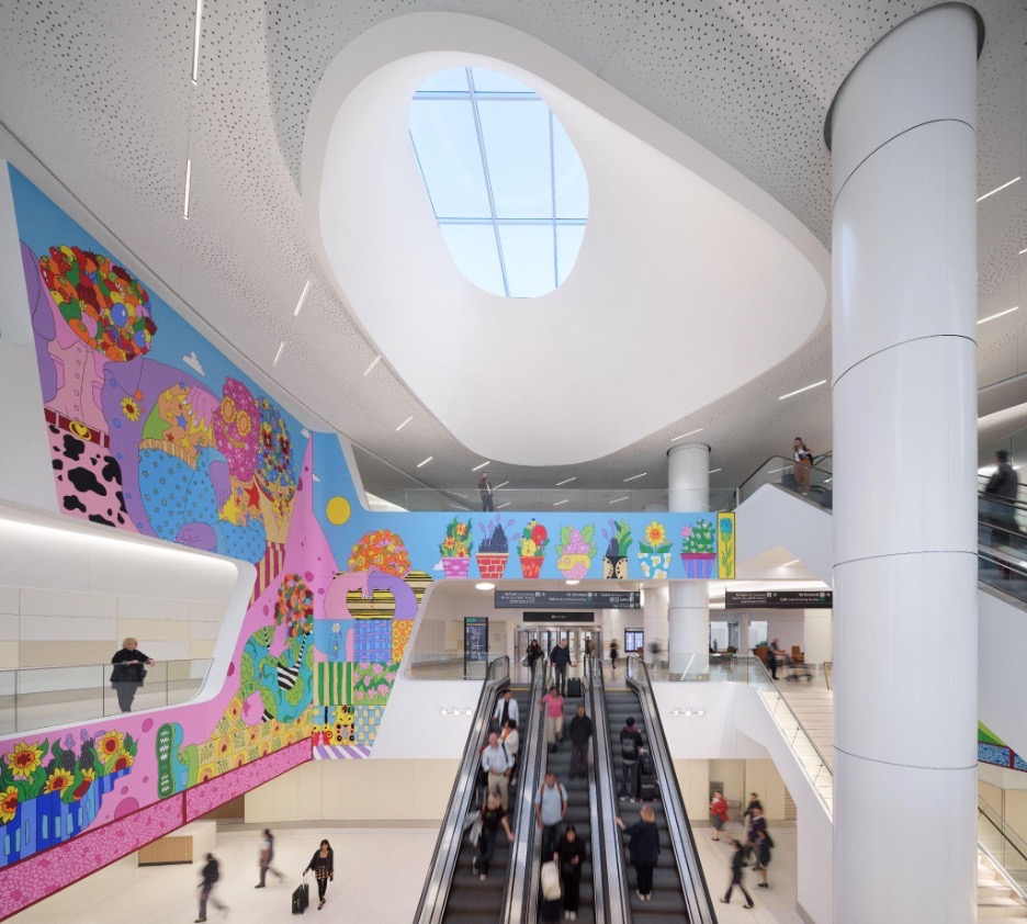 Interior of airport terminal with escaltor and biomorphic skylight