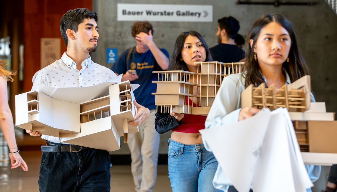 Students carrying architectural models