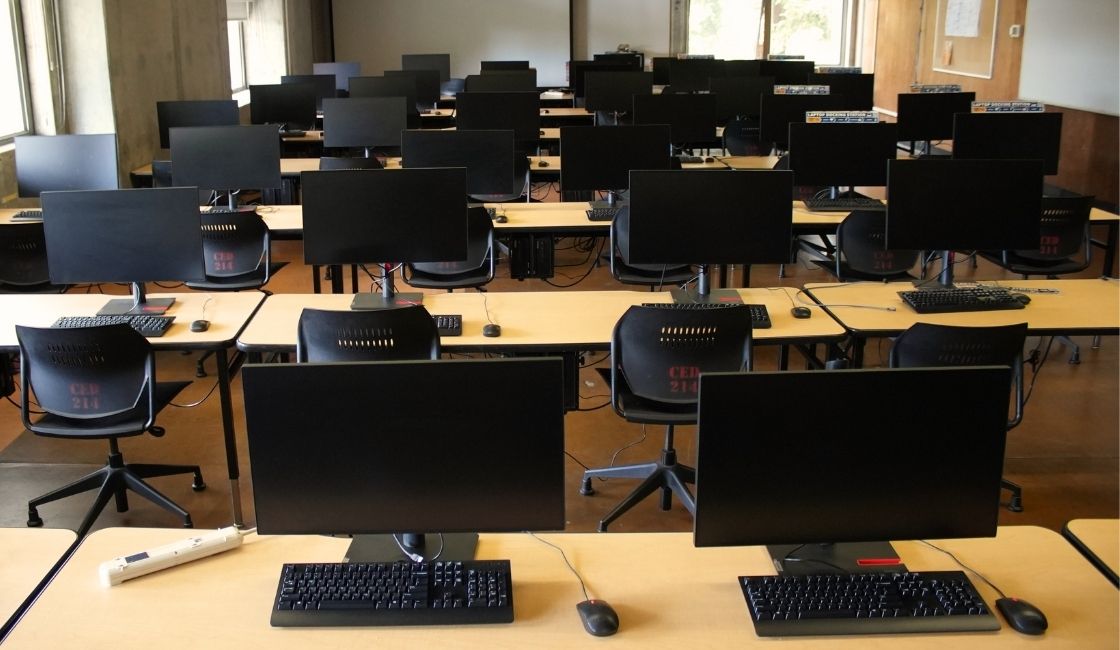 Chairs and desks with computers in Computer Lab